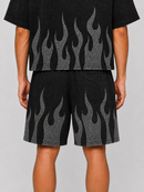 A person shown from the back wearing a matching black short-sleeve crop top and shorts set with a gray flame pattern, against a light gray studio background. Rare Peace black rhinestone flame T-shirt and shorts set at Fresh N Fitted – front view