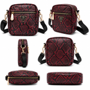 Red snake print bags with gold accents on a white background