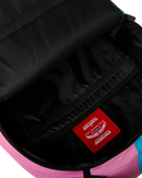 Close-up of the interior of a backpack showing a black mesh-lined compartment with a red sewn-in brand patch that reads 'Spartan Supply Co.'.