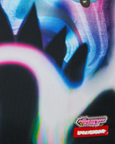 Close-up of a colorful graphic print featuring abstract blue, black, white, and pink shapes, with the visible text logo 'POWERPUP SCIENCE' and 'SPRAYGROUND' in the lower right corner.