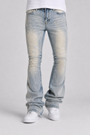 Light-wash distressed denim jeans with a faded, washed-out look, shown on a model from the waist down wearing white sneakers against a light gray studio background.