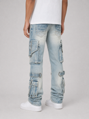 A person shown from the waist down wearing light-wash blue cargo jeans with multiple flap pockets, a white t-shirt, and white sneakers against a light gray studio background.