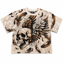 Rebel Minds cream tapestry t-shirt with a large graphic of a winged skull and feathers. Features rhinestone detailing.