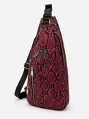 Red snake print sling bag with black accents on a white background